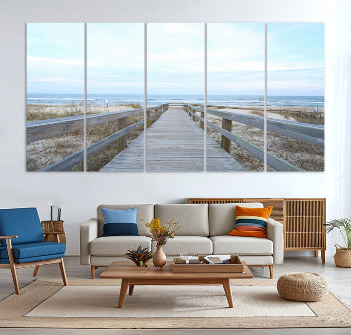 Wooden boardwalk leading to a peaceful beach with gentle ocean waves under a soft pastel sky, perfect for coastal and nautical home decor.
