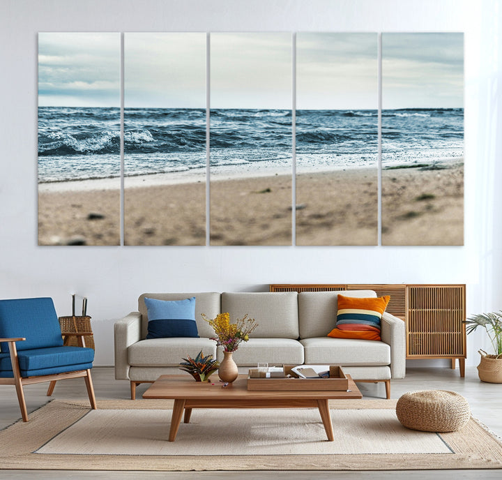 A moody ocean scene with gentle waves washing onto a sandy beach under a cloudy sky, creating a peaceful and coastal atmosphere.