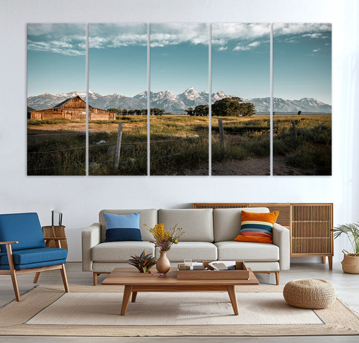 A rustic farmhouse with a wooden barn set against majestic mountain peaks under a soft blue sky, evoking peaceful countryside charm.