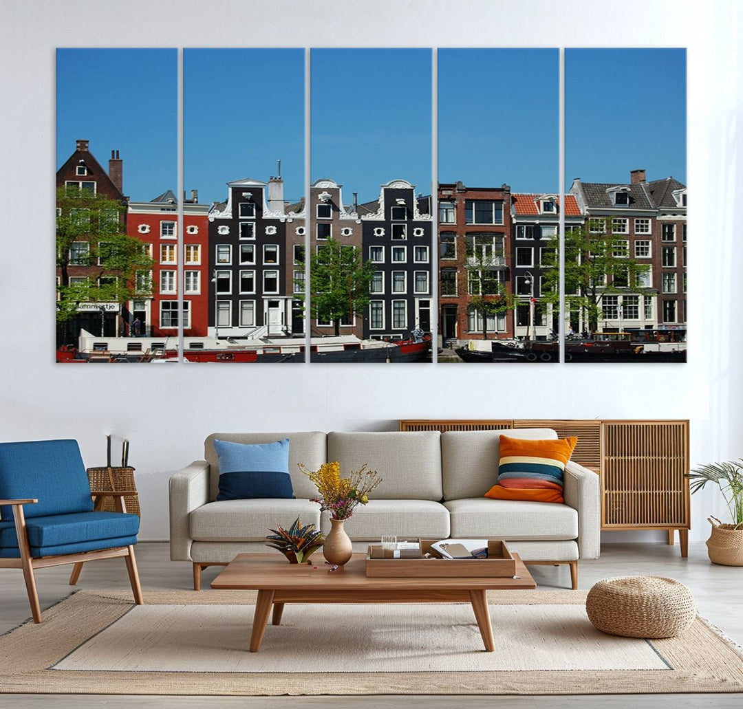 The Amsterdam City Wall Art Canvas Print showcases colorful traditional canal houses and boats set against a clear blue sky.