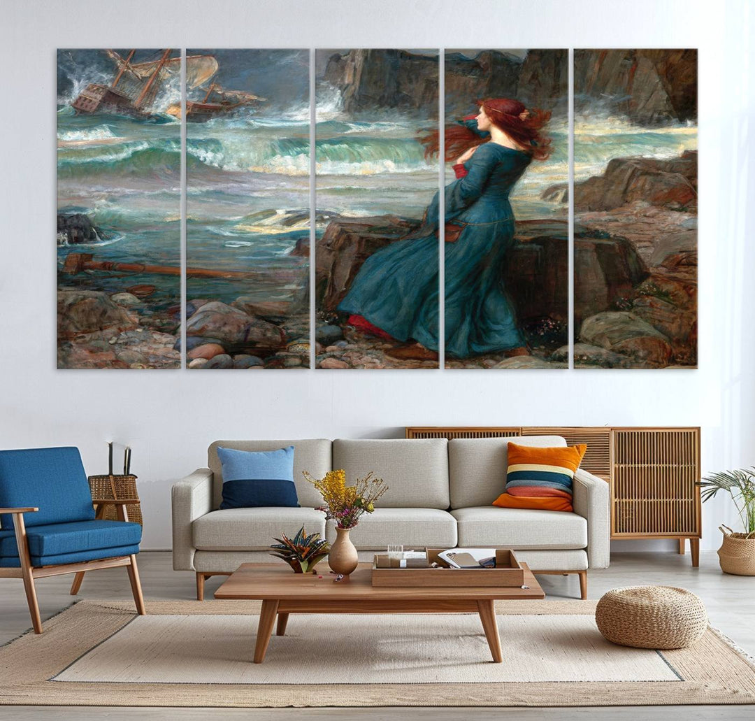 The Miranda by the Shore Wall Art Canvas Print depicts a woman in a blue dress standing by the sea, watching a shipwreck.