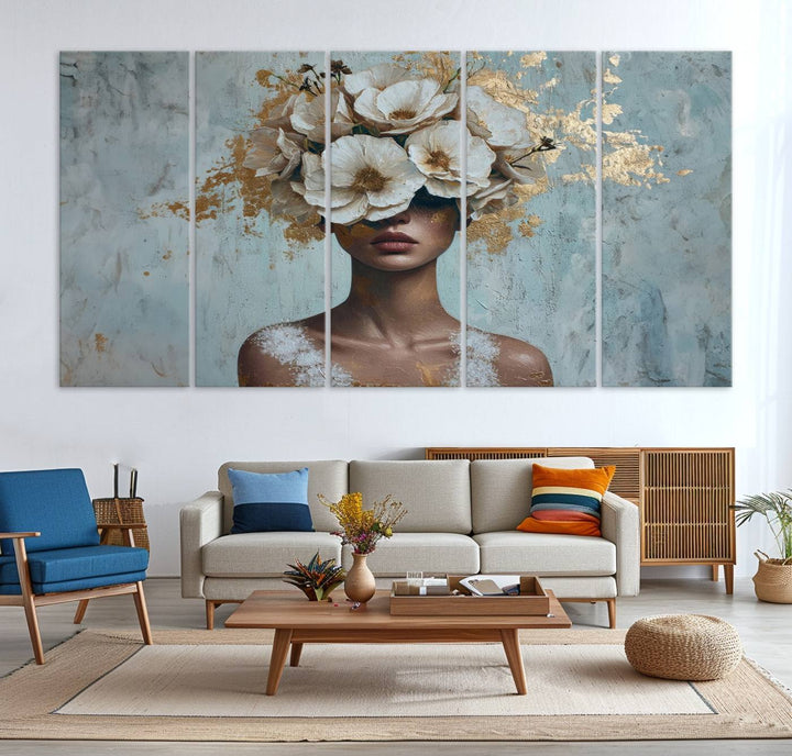 The Golden Petal Silhouette Woman Wall Art Canvas Print, a large 3-panel canvas with a textured gold floral design, serves as a luxurious centerpiece in modern glam settings. The artwork depicts a woman with flowers over her eyes against a textured background and hangs elegantly.