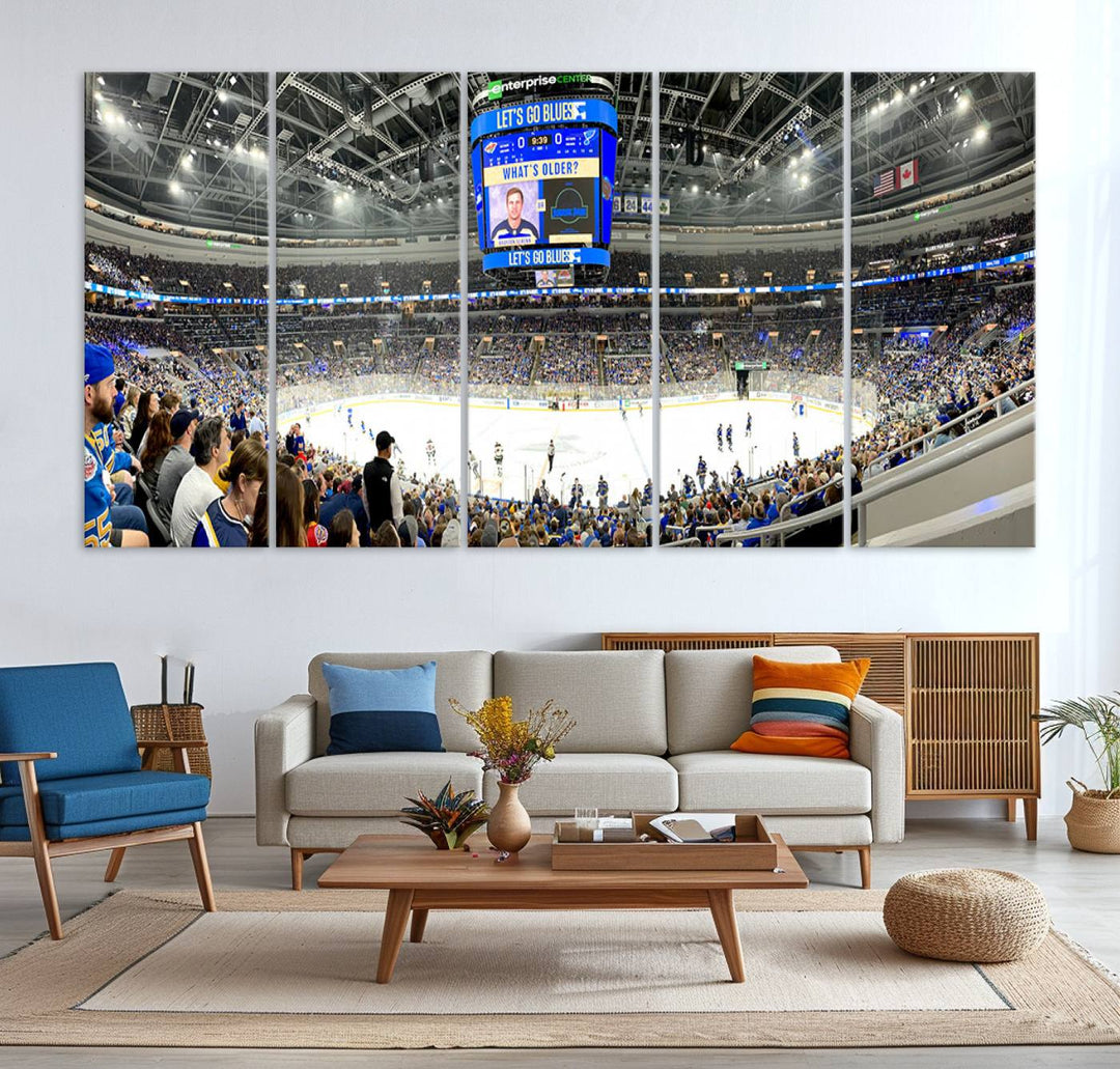 Wall art prints depicting the bustling scenes of the St. Louis Blues being cheered on by a full house at the Enterprise Center, beneath a large scoreboard.