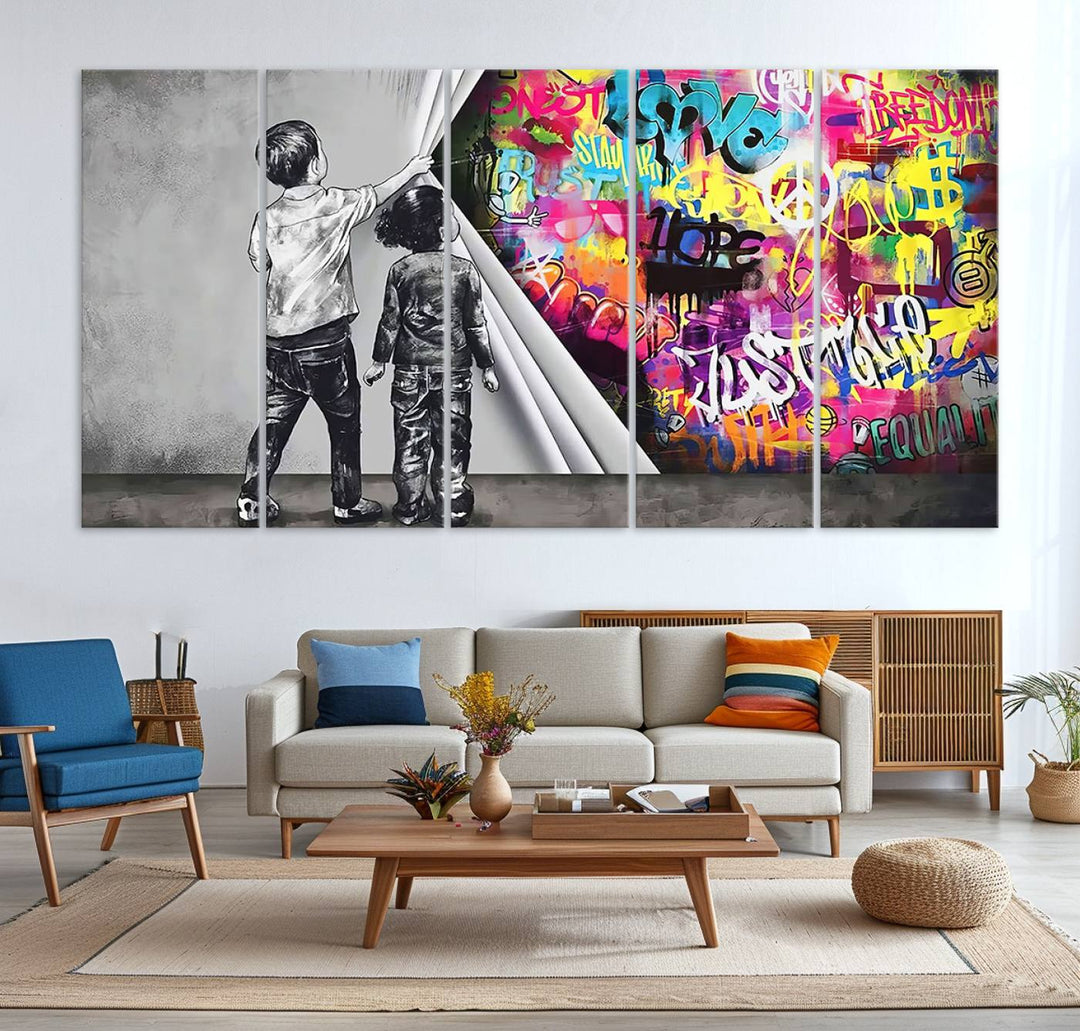 The Banksy Print - Street Art Canvas features a vibrant and bold image of two children lifting a curtain to reveal colorful graffiti. It's ready to hang, adding an urban modern decor vibe.