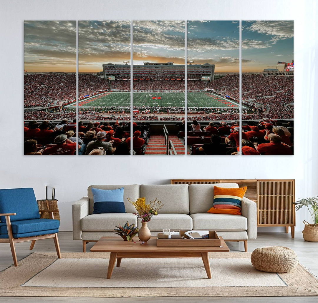 The living room features a stunning triptych of Lincoln Memorial Stadium wall art canvas print, celebrating the University of Nebraska Cornhuskers football team. This piece serves as captivating wall art, showcasing a gallery-quality finish.