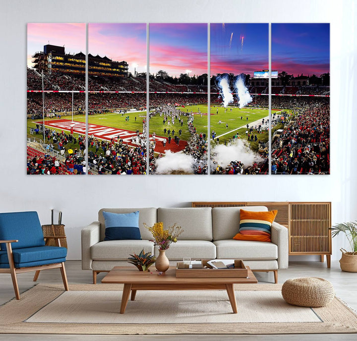 The wall art features a canvas print of the Stanford Cardinal football team, capturing players, fireworks, and smoke against the backdrop of a sunset at Stanford Stadium.