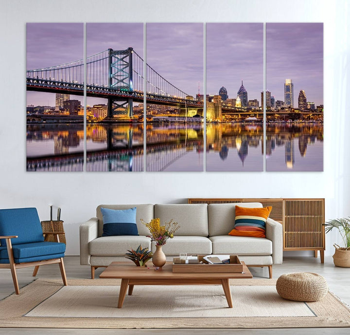 An Extra Large Wall Art Philadelphia Canvas Print, featuring a gallery-quality finish, captures the lit-up Ben Franklin Bridge and city buildings perfectly reflected on the water at sunset.