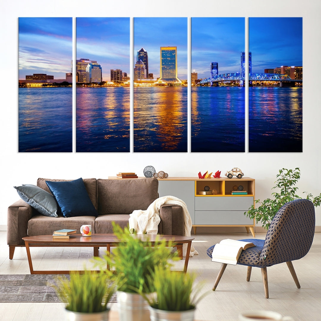 A cozy living room features the Jacksonville Wall Art Canvas Print, a large triptych crafted on museum-quality canvas that beautifully depicts the Jacksonville city skyline at sunset.