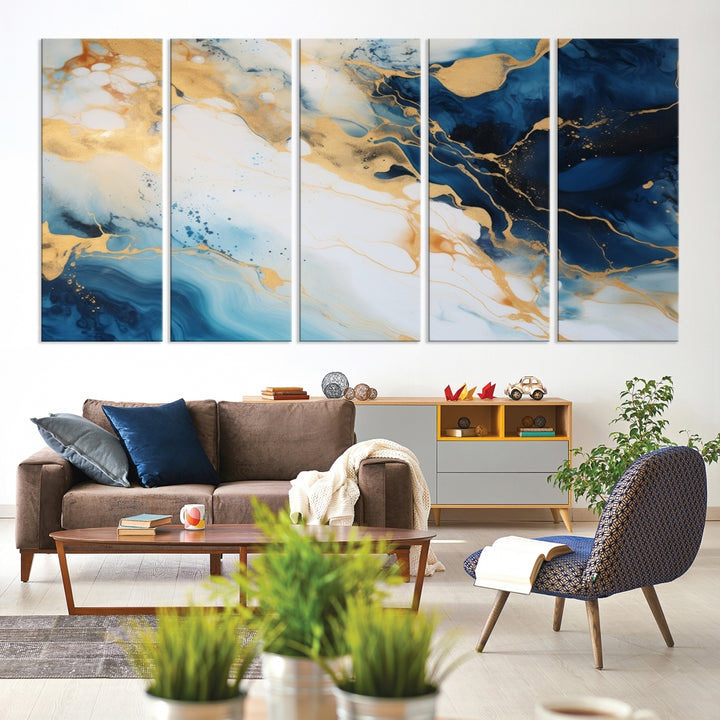 A modern living room featuring museum-quality Blue Gold Abstract Wall Art Print Contemporary art in a triptych arrangement.