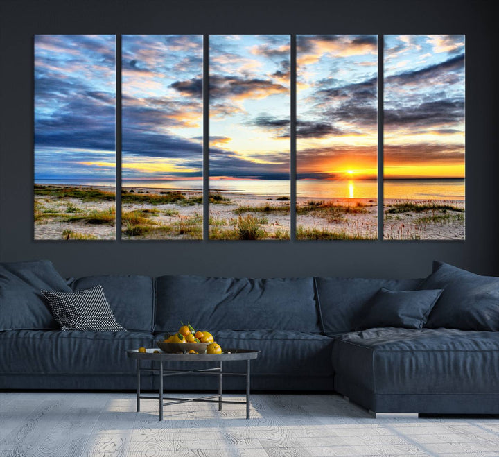 The Sunset On The Ocean canvas wall art features a beautiful beach sunset with grass and clouds.