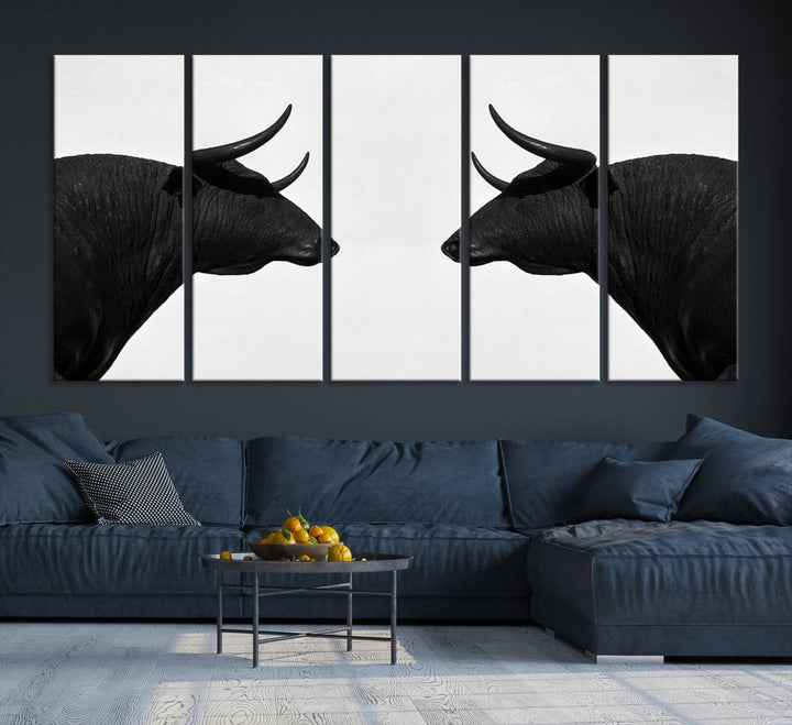 A framed canvas print featuring two black bull silhouettes, perfect for modern rustic decor.