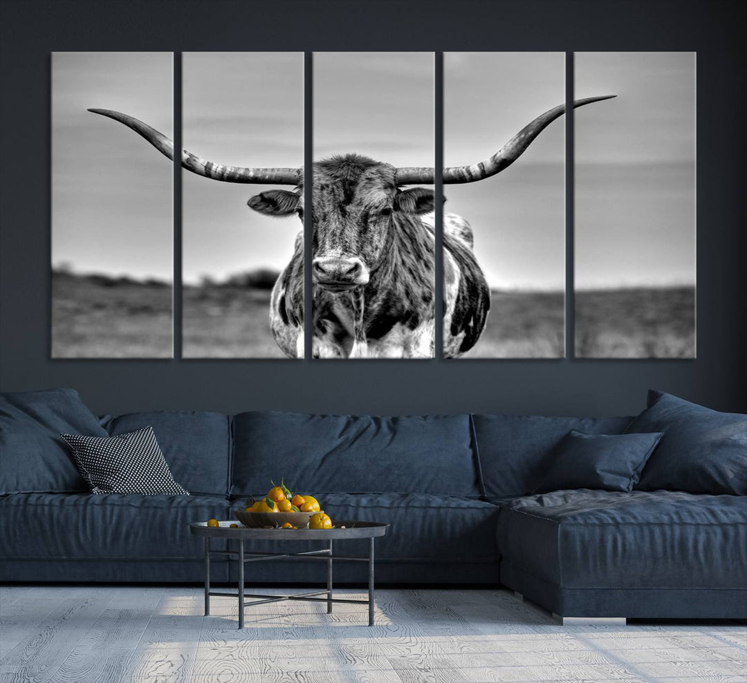 The Texas Longhorn Cow wall art, divided into three panels, is of gallery quality and displayed on a dark wall.