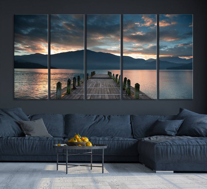 The Mountain Lake Wood Pier Canvas Wall Art depicts a serene lake and mountains, enhancing the beauty of any space.