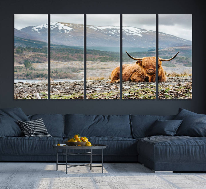 Highland Cow Horn Farm Wall Art Canvas Print is displayed against a wooden wall featuring a mountainous backdrop.