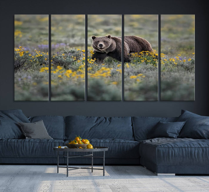 The "Grizzly 399 in Wild Flowers Wall Art Canvas Print" features a grizzly bear strolling through a field of yellow and purple flowers, beautifully showcased as a triptych. This handcrafted piece, proudly made in the USA, adds charm and sophistication to your space.