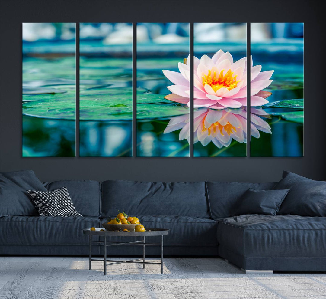 The Lotus Flower Canvas Print showcases a pink water lily with a yellow center gracefully floating on a calm pond.