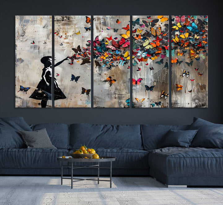 The Banksy Butterfly Girl 3-Piece Modern Graffiti Canvas Wall Art features a silhouette of a girl reaching for butterflies.