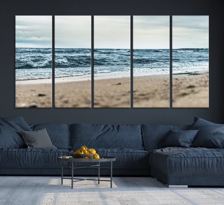 A moody ocean scene with gentle waves washing onto a sandy beach under a cloudy sky, creating a peaceful and coastal atmosphere.