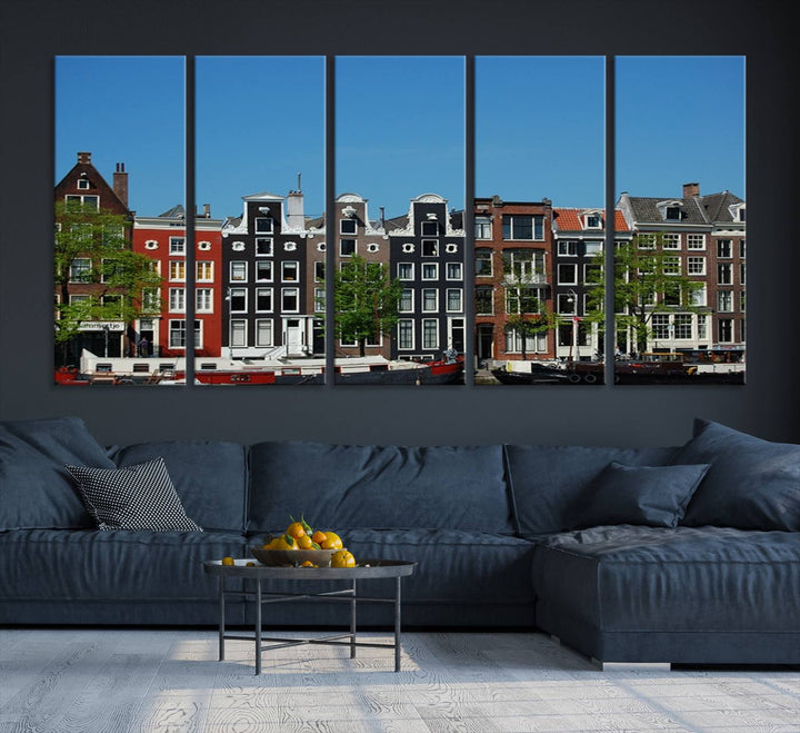 The Amsterdam City Wall Art Canvas Print showcases colorful traditional canal houses and boats set against a clear blue sky.