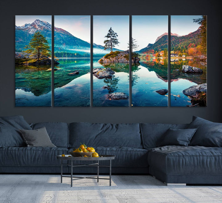 The 3-panel wall art showcases a serene mountain lake with rocky islands and trees, creating an ideal focal point for dining rooms or offices.