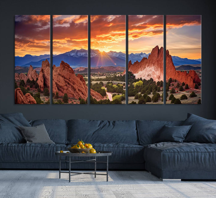 A vibrant sunset over the Rocky Mountains with red rocks.