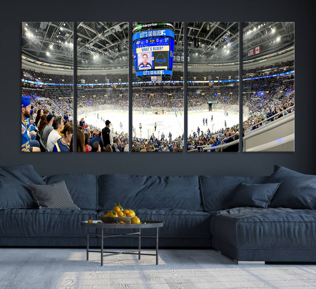 Wall art prints depicting the bustling scenes of the St. Louis Blues being cheered on by a full house at the Enterprise Center, beneath a large scoreboard.