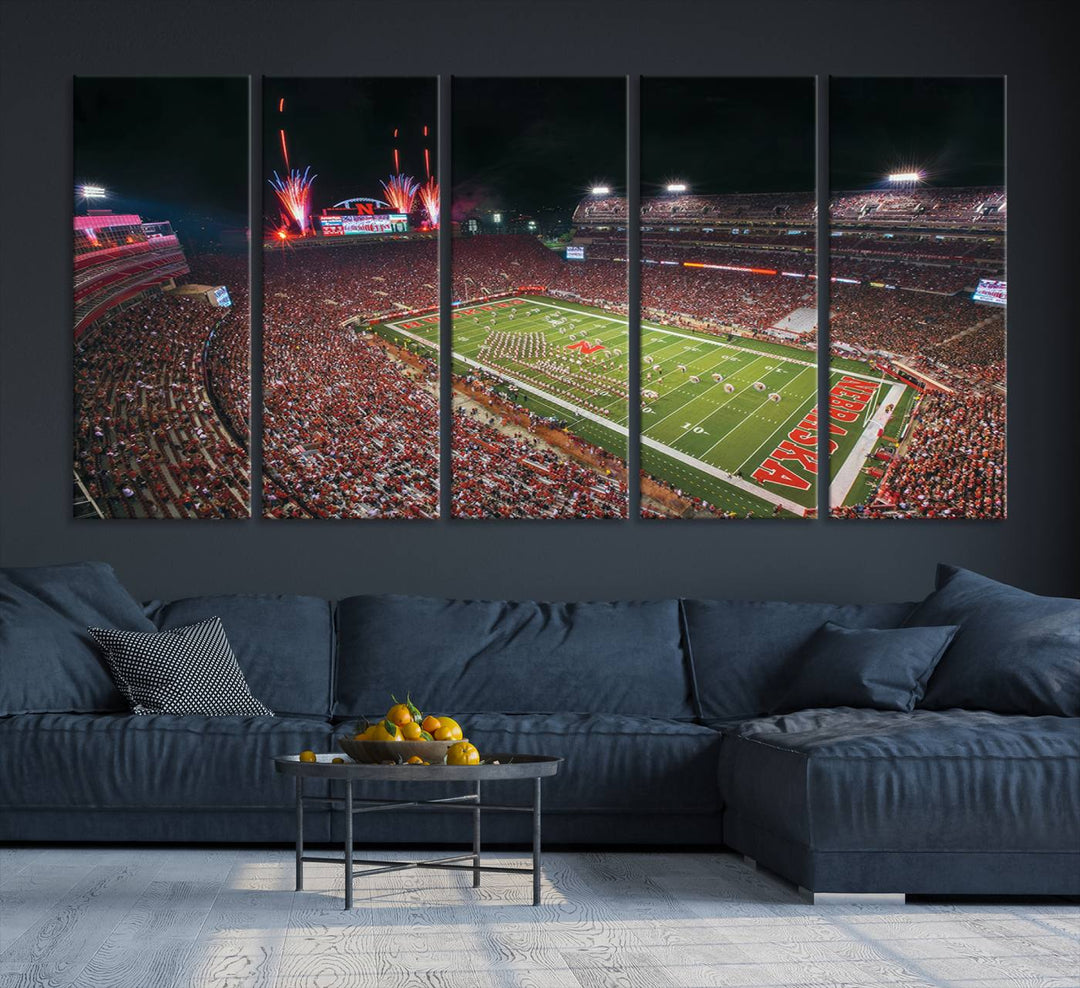 The University of Nebraska Cornhuskers Football Team Print, featuring Lincoln Memorial Stadium in a vibrant triptych canvas with fireworks above and a gallery-quality finish, is elegantly displayed.