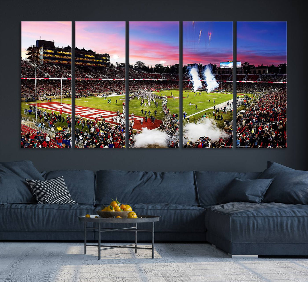 The wall art features a canvas print of the Stanford Cardinal football team, capturing players, fireworks, and smoke against the backdrop of a sunset at Stanford Stadium.