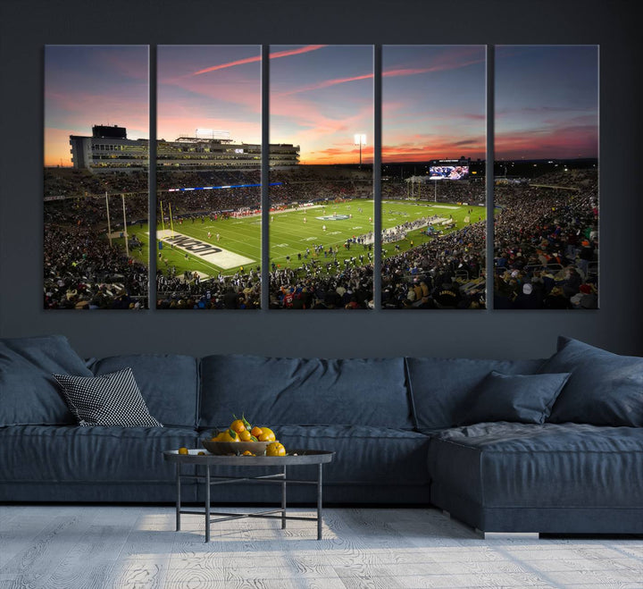 This wall art canvas print captures UCONN Huskies fans energizing a sunset scene at East Hartfords Pratt & Whitney Stadium.