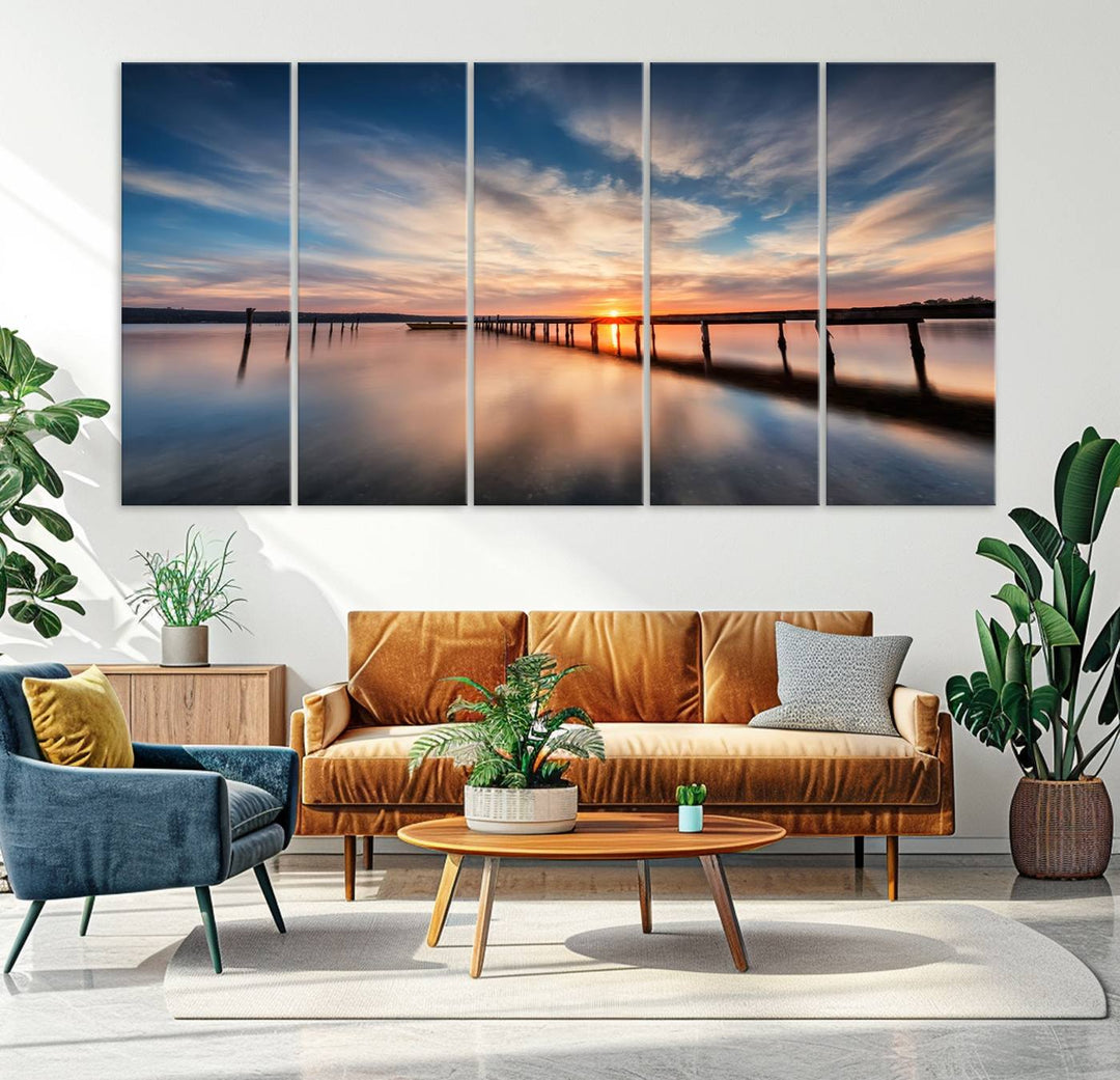 The Sunset Pier Canvas features a serene coastal landscape with vibrant hues under cloudy skies, ideal for modern decor.