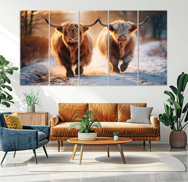 The wall art is a Scottish Highland Cow Horn canvas print featuring cows on a snowy path bathed in warm sunlight, serving as a rustic decor piece.