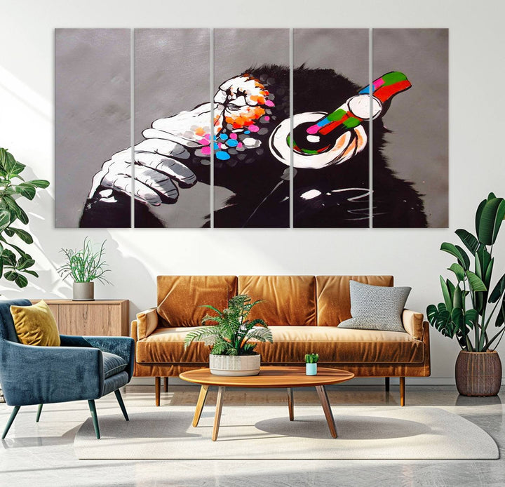 A vibrant triptych, the "DJ Monkey Listening to Music" wall art print, features a Banksy-inspired large canvas adorned with colorful modern pop art. This striking piece elegantly enhances the room with its dynamic and lively depiction.