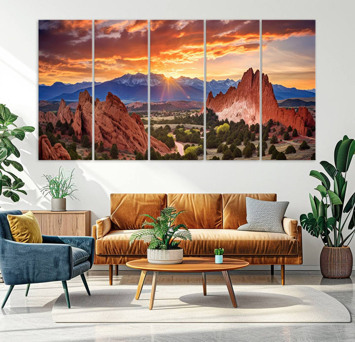 A vibrant sunset over the Rocky Mountains with red rocks.