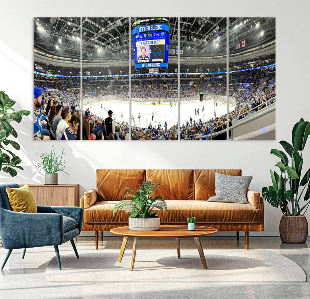 Wall art prints depicting the bustling scenes of the St. Louis Blues being cheered on by a full house at the Enterprise Center, beneath a large scoreboard.