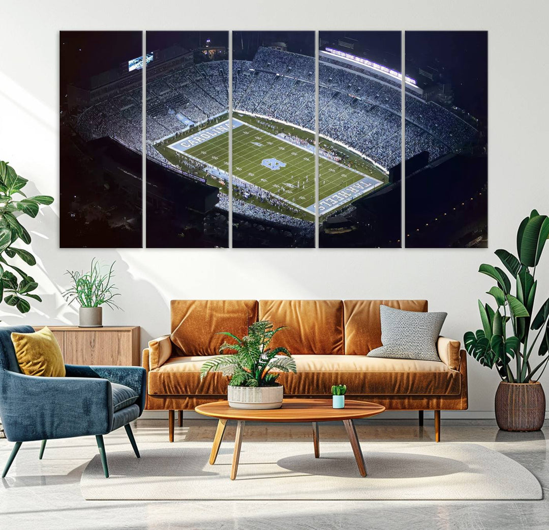 A University of North Carolina Tar Heels Football Team Print, showcasing Chapel Hill's Kenan Memorial Stadium, hangs in a modern dining room, adding a gallery-quality finish that enhances the entire space.