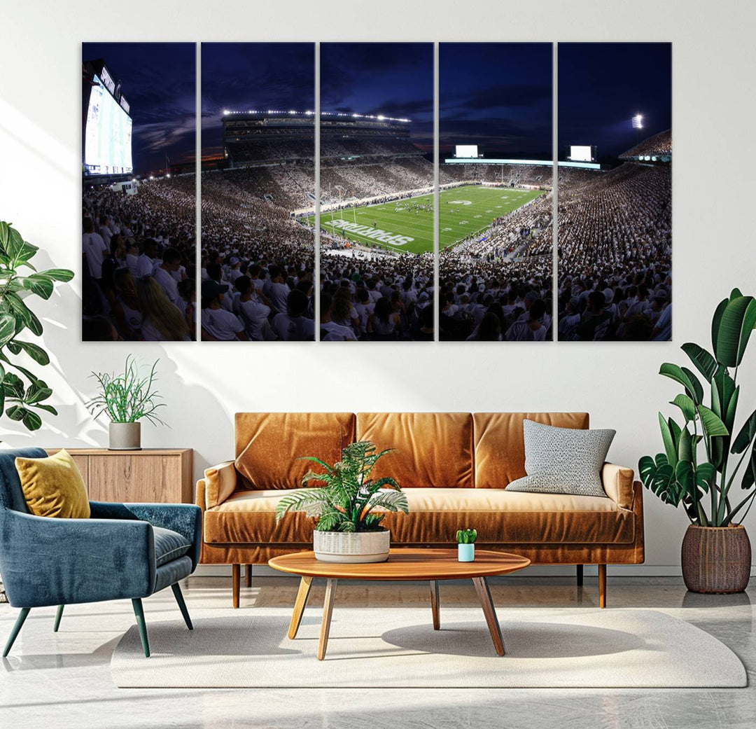 A packed football stadium at night, with bright lights and fans in white, depicted in a Michigan State Spartans Stadium wall art.