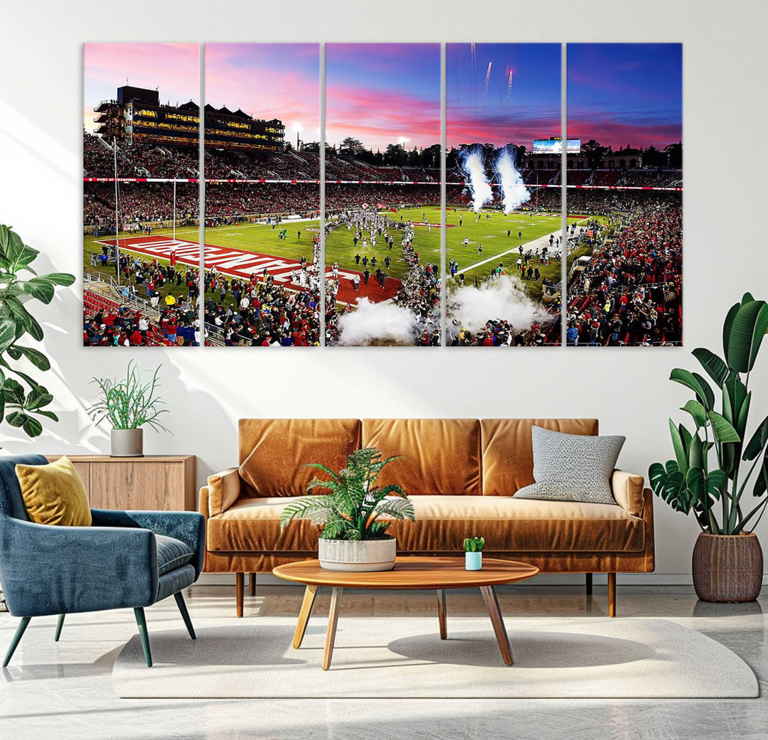 The wall art features a canvas print of the Stanford Cardinal football team, capturing players, fireworks, and smoke against the backdrop of a sunset at Stanford Stadium.