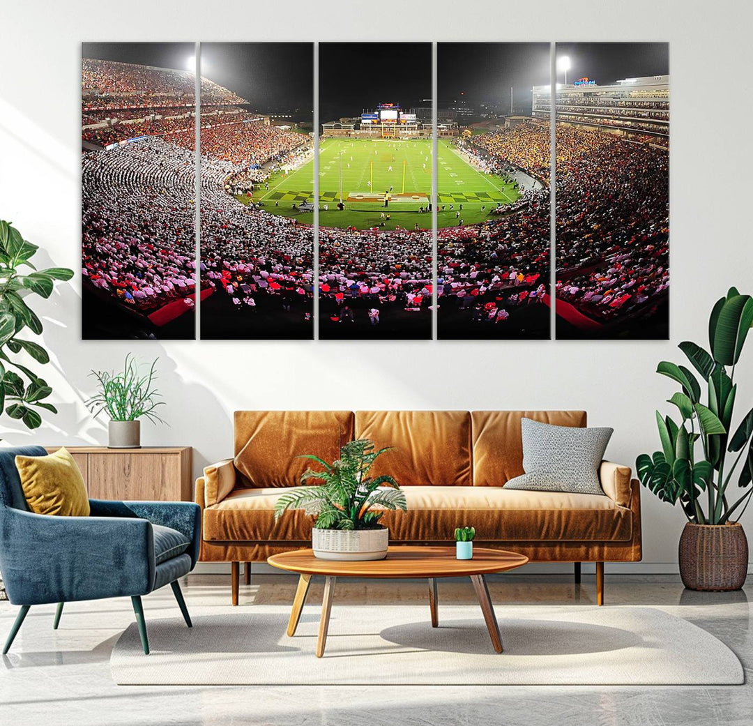 The Maryland Terrapins Football Wall Art Canvas showcases a packed SECU Stadium at night with a bright field and cheering fans.