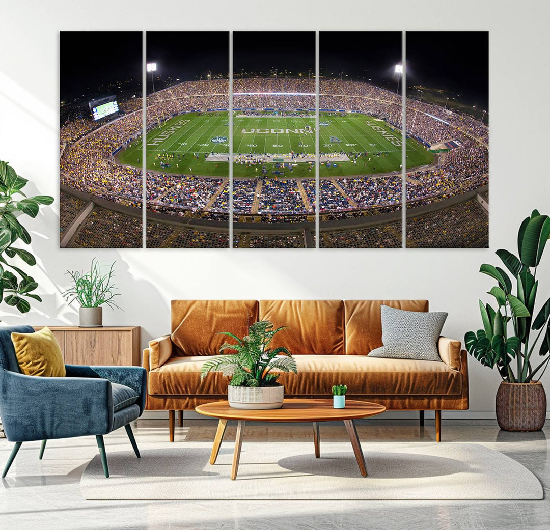 A large football stadium at night, featuring the UCONN Huskies, is depicted on the East Hartford Pratt & Whitney Stadium Wall Art Canvas Print.