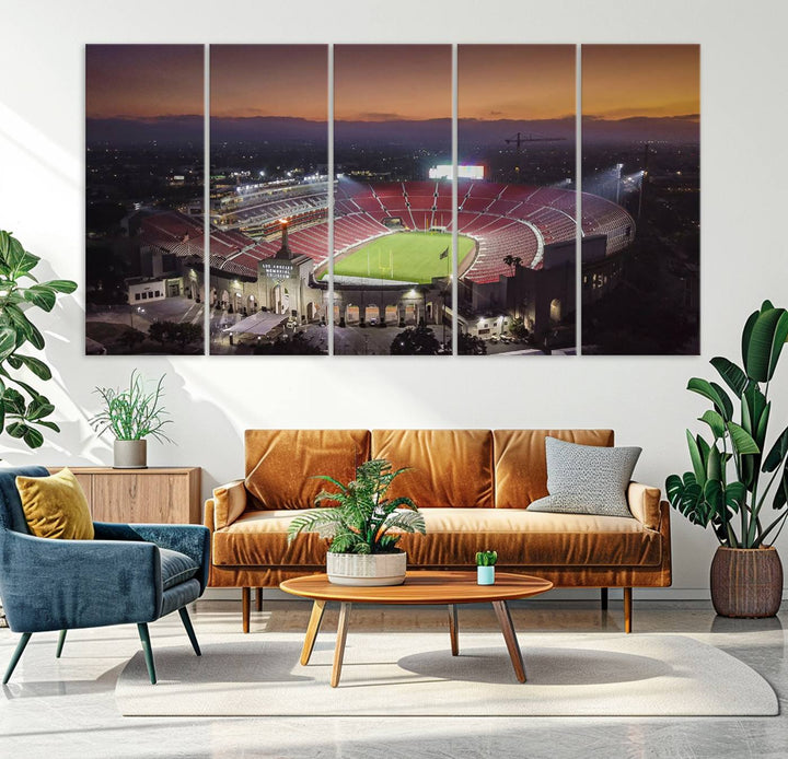 The USC Trojans Stadium canvas captures Memorial Coliseum at twilight, showcasing red seats and a green field beneath an orange sky.