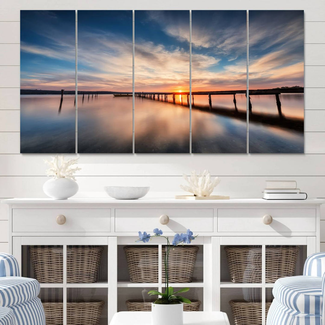 The Sunset Pier Canvas features a serene coastal landscape with vibrant hues under cloudy skies, ideal for modern decor.