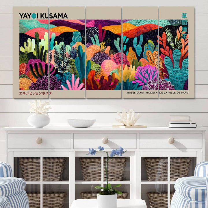 The framed Yayoi Kusama wall art adds vibrancy above the blue couch.