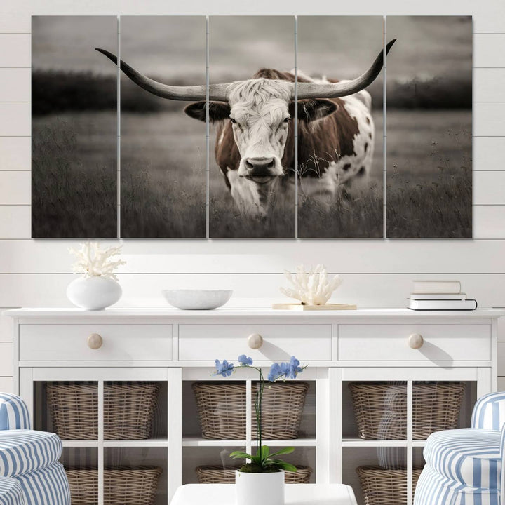 The Texas Longhorn Cow Canvas Wall Art Print adds a rustic touch to a living room.