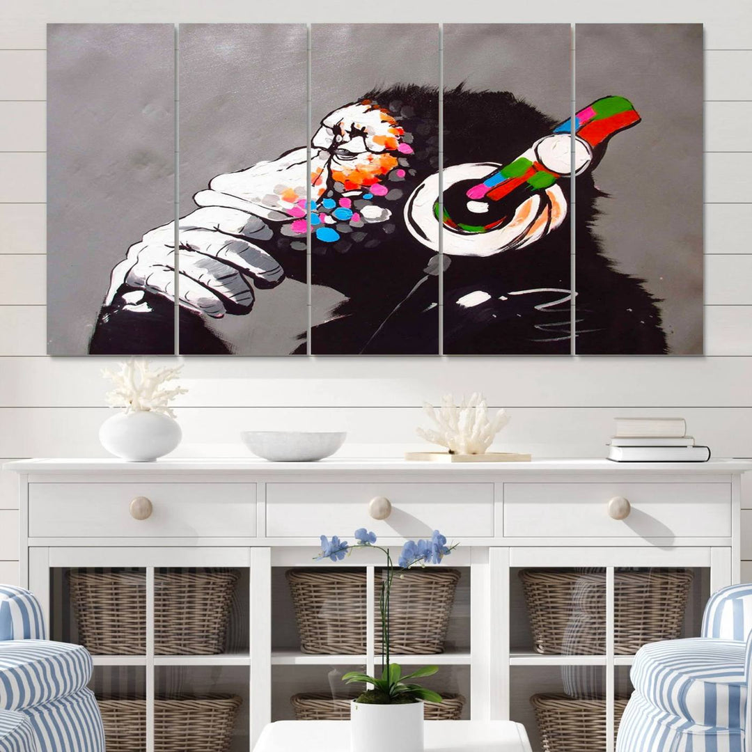 A vibrant triptych, the "DJ Monkey Listening to Music" wall art print, features a Banksy-inspired large canvas adorned with colorful modern pop art. This striking piece elegantly enhances the room with its dynamic and lively depiction.