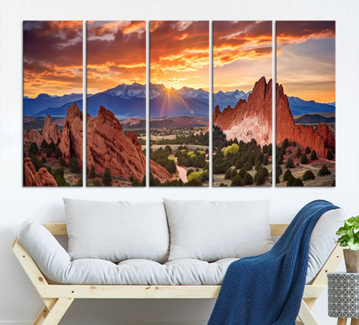 A vibrant sunset over the Rocky Mountains with red rocks.
