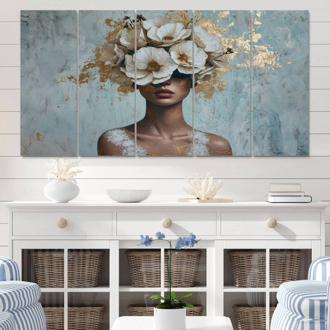 The Golden Petal Silhouette Woman Wall Art Canvas Print, a large 3-panel canvas with a textured gold floral design, serves as a luxurious centerpiece in modern glam settings. The artwork depicts a woman with flowers over her eyes against a textured background and hangs elegantly.