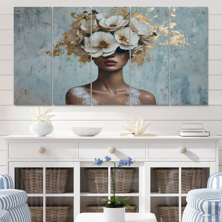 The Golden Petal Silhouette Woman Wall Art Canvas Print, a large 3-panel canvas with a textured gold floral design, serves as a luxurious centerpiece in modern glam settings. The artwork depicts a woman with flowers over her eyes against a textured background and hangs elegantly.