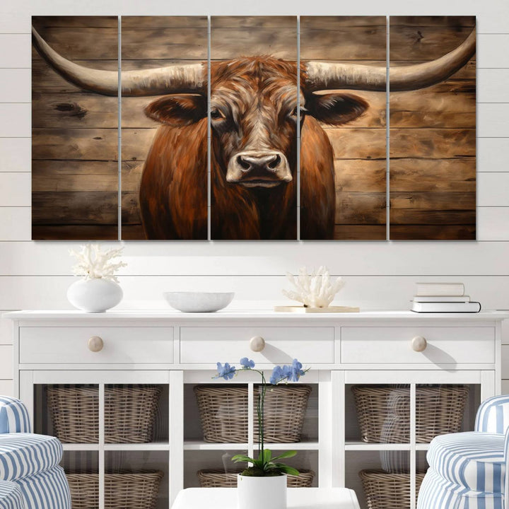 The Longhorn Bull Wall Art, a ready-to-hang canvas print, showcases an image of a brown longhorn cow set against a wooden background, perfect for those looking to enhance their space with rustic farmhouse and western barn decor.