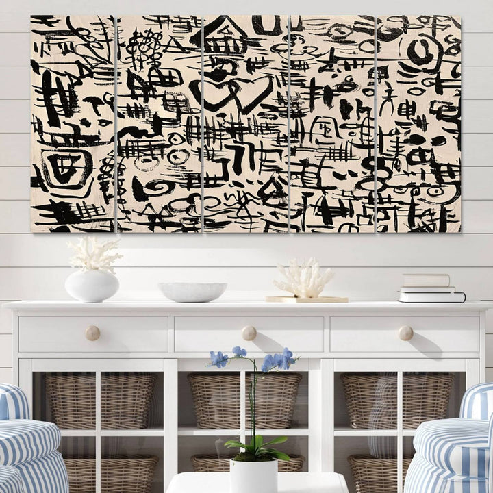 The Abstract Love and Chaos canvas is a museum-quality print featuring black symbols on a beige background, adorned with a heart and scribble design. It is framed to enhance its artistic appeal.