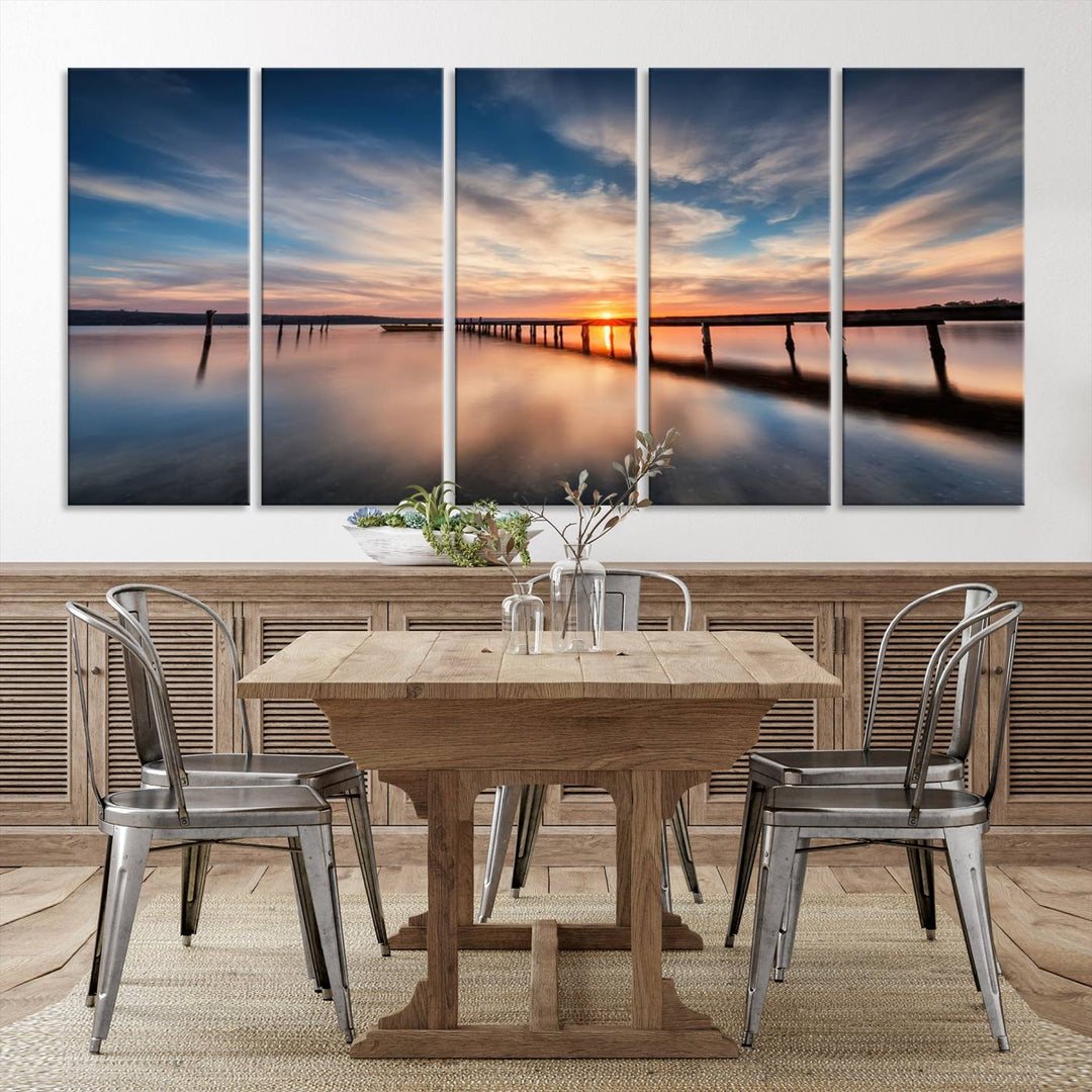 The Sunset Pier Canvas features a serene coastal landscape with vibrant hues under cloudy skies, ideal for modern decor.